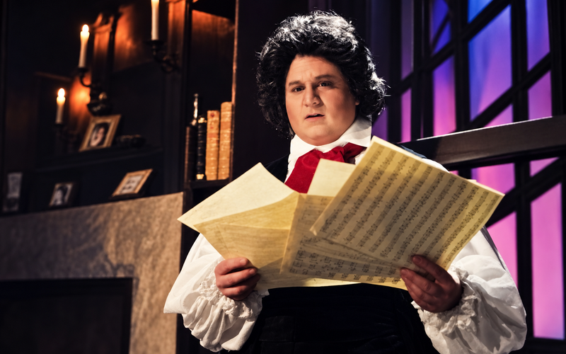 Bradley Miller as Beethoven with sheet music — Los Angeles production